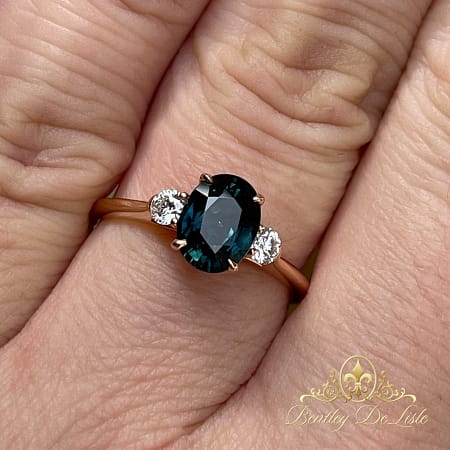 Teal-oval-sapphire-argyle-diamond-ring-11448-hand-2-bentley-de-lisle